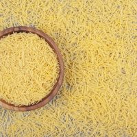 Bunch of uncooked pasta in wooden bowl Bunch of uncooked pasta in wooden bowl. High quality photo